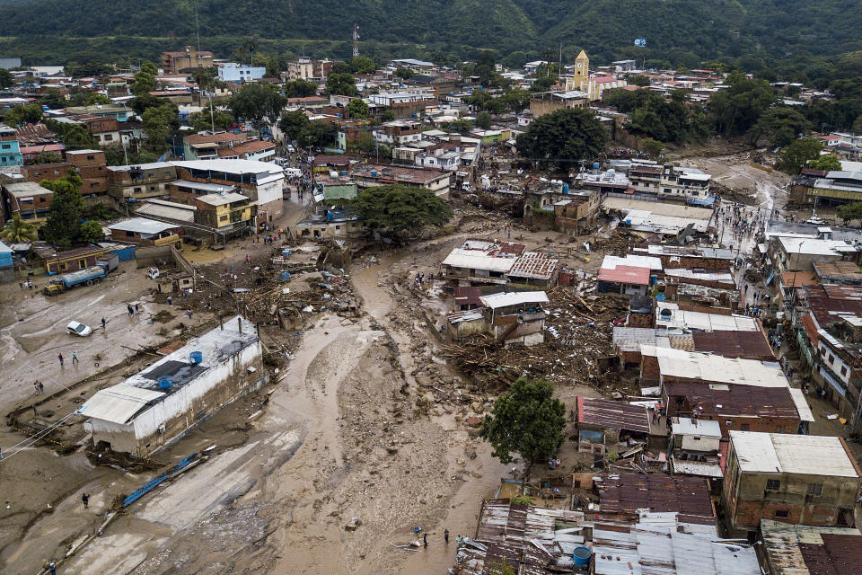 Streets are flooded after heavy rains caused a river to overflow in Las Tejerias, Venezuela, Sunday, Oct. 9, 2022. (AP Photo/Matias Delacroix)