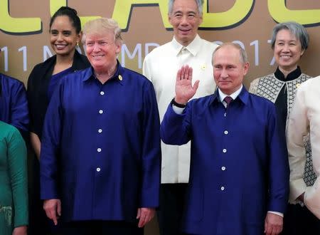 U.S. President Donald Trump and Russian President Vladimir Putin take part in a family photo at the APEC summit in Danang, Vietnam November 10, 2017. Sputnik/Mikhail Klimentyev/Kremlin via REUTERS