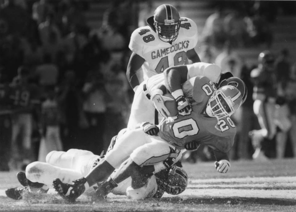 UNC’s Natrone Means gets hit by South Carolina’s Keith Franklin, bottom, and Chris Rumph as he runs near the goal line during North Carolina’s 21-17 victory in November 1991.