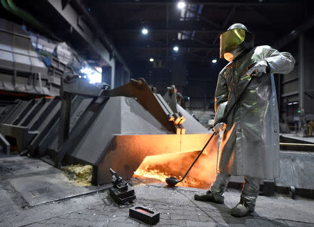 FILE PHOTO - A worker of German steel manufacturer Salzgitter AG stands in front of a furnace at a plant in Salzgitter, Germany, March 1, 2018. REUTERS/Fabian Bimmer