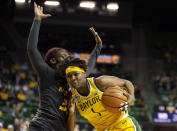 Baylor forward NaLyssa Smith (1) drives to the basket as Missouri guard Aijha Blackwell (33) defends in the first half of an NCAA college basketball game in Waco, Texas, Saturday, Dec. 4, 2021. (AP Photo/Emil Lippe)