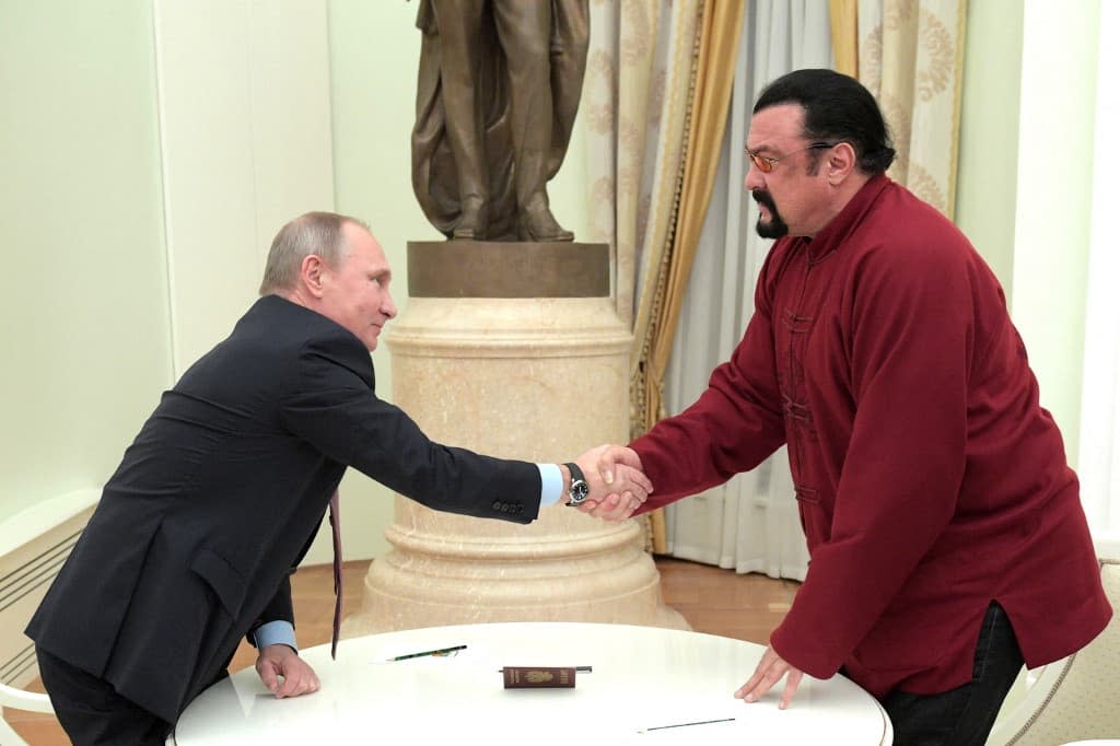 Vladimir Poutine et Steven Seagal à Moscou le 25 novembre 2016, après la remise de son passeport russe à l'acteur. - Alexey DRUZHININ / SPUTNIK / AFP