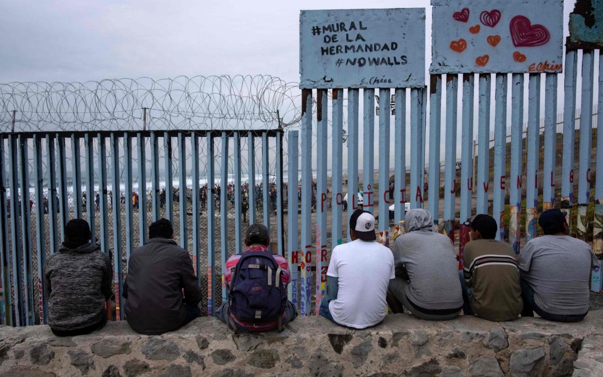 Men next to a sign reading