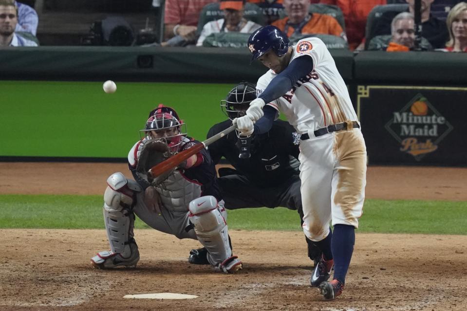 Houston Astros' George Springer hits an RBI double during the eighth inning of Game 1 of the baseball World Series against the Washington Nationals Tuesday, Oct. 22, 2019, in Houston. (AP Photo/Eric Gay)