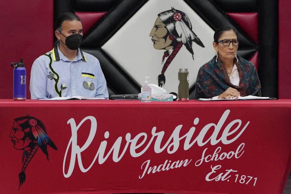 Bryan Newland, left, assistant secretary for Indian Affairs, and Deb Haaland, right, U.S. Secretary of the Interior, listen a meeting to hear about the painful experiences of Native Americans who were sent to government-backed boarding schools designed to strip them of their cultural identities Saturday, July 9, 2022 in Anadarko, Okla. Native American tribal elders who were once students at government-backed Indian boarding schools testified Saturday about the hardships they endured, including beatings, whippings, sexual assaults, forced haircuts and painful nicknames. (AP Photo/Sue Ogrocki)