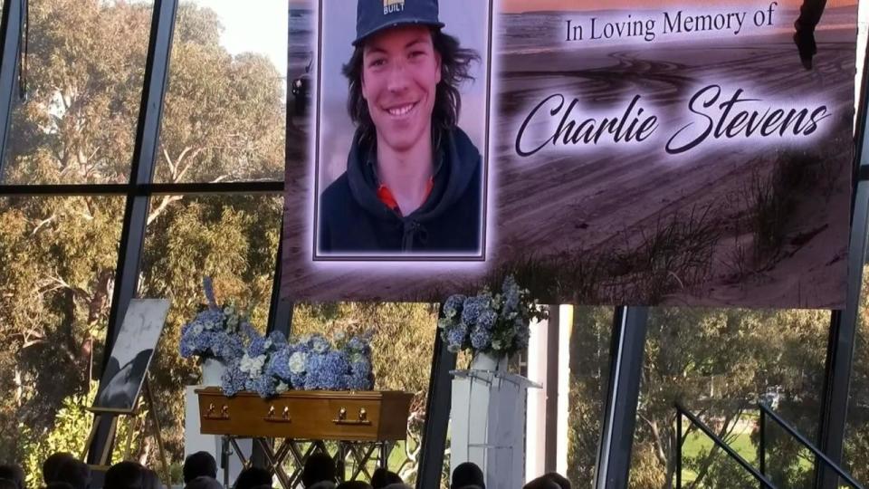 Mourners attend the memorial service for Charlie Stevens