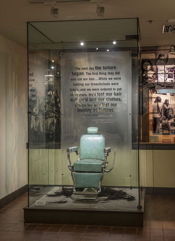 'Arrival' section with barber chair where students had hair cut upon arrival at federal boarding schools in the original 'Away from Home: American Indian Boarding School Stories' exhibition at the Heard Museum.