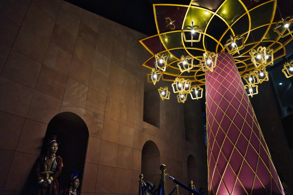 Performers await their time to dance next to a Diwali display at the India pavilion at Expo 2020 in Dubai, United Arab Emirates, Thursday, Nov. 4, 2021. Millions of people across Asia are celebrating the Hindu festival of Diwali, which symbolize new beginnings and the triumph of good over evil and light over darkness. (AP Photo/Jon Gambrell)