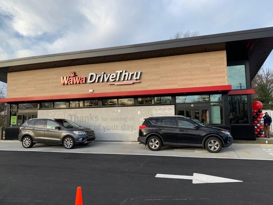 Customers wait in line at the first-ever Wawa drive-thru-only standalone store that opened in Falls on Friday.