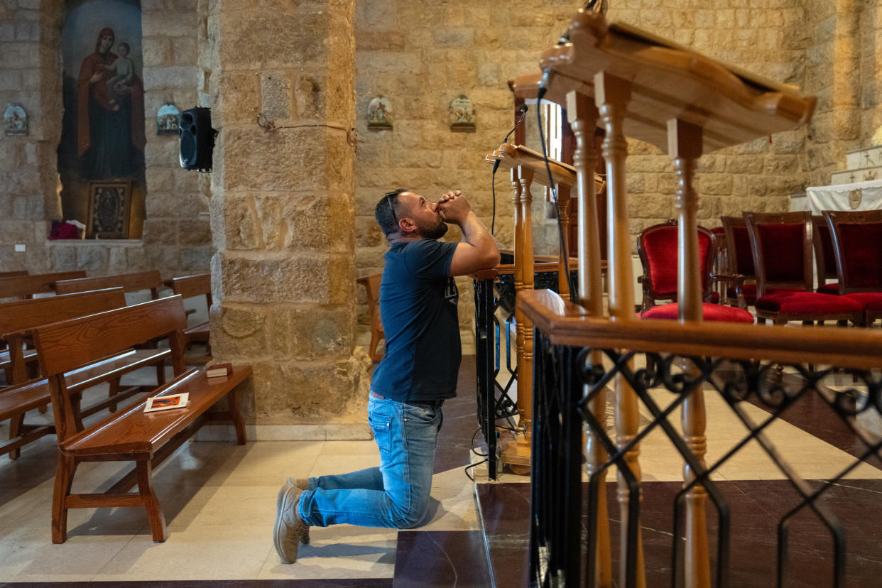 KLAYAA, LEBANON - OCTOBER 4: A member of the Maronite Christian community prays as he waits for a priest to confirm if the community will leave or remain in place following an Israeli Defence Force notice to evacuate the village, on October 4, 2024 in Klayaa, Lebanon. Israel continued airstrikes on Beirut and its southern suburbs as its military announced a ground offensive in Lebanon, part of what it said would be a 