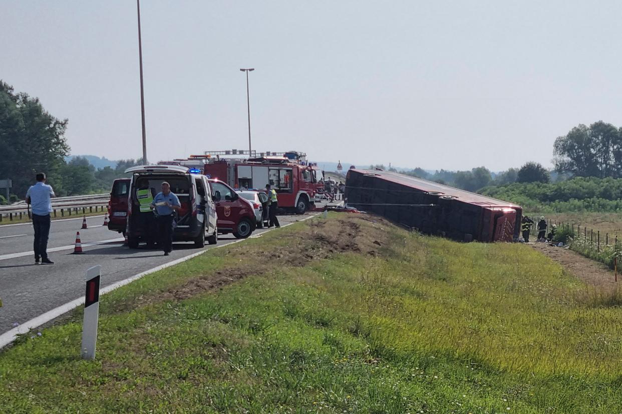 Emergency crews work at the site of a bus accident near Slavonski Brod, Croatia, Sunday, July 25, 2021 (AP)