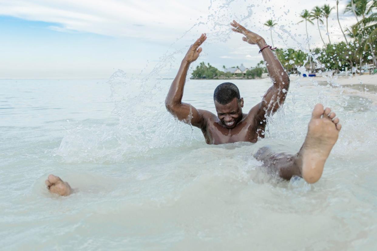 man splashing in water in La Romana Domincan Republic