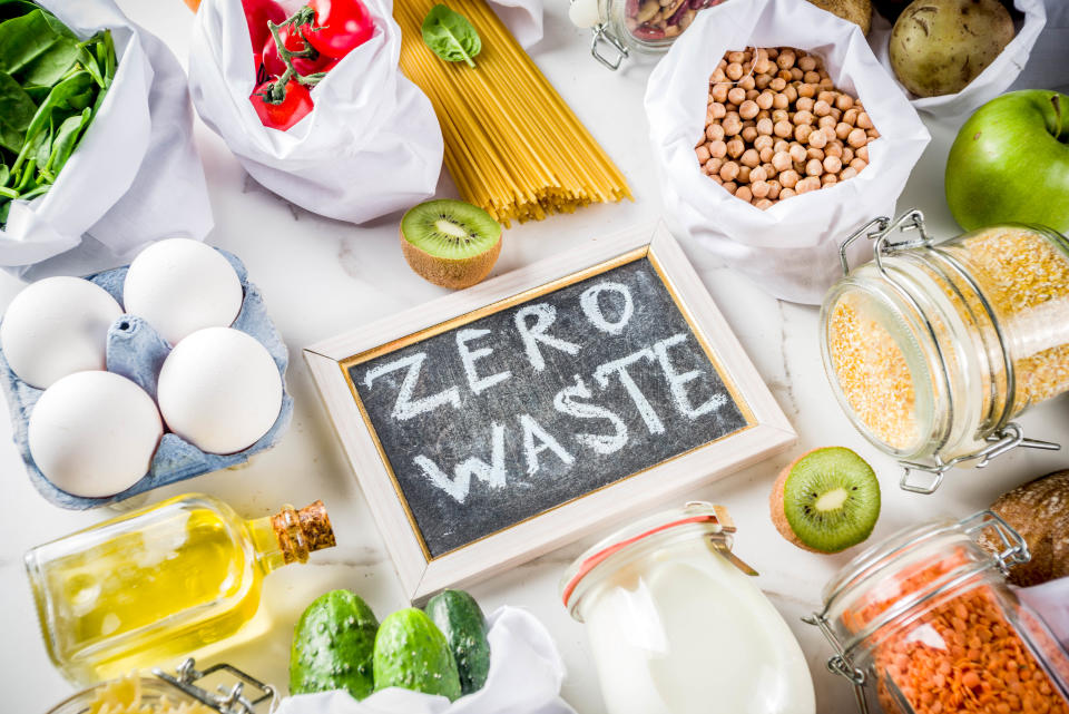 Zero waste shopping and sustanable lifestyle concept, various farm organic vegetables, grains, pasta, eggs and fruits in reusable packaging supermarket bags. copy space top view, white concrete table