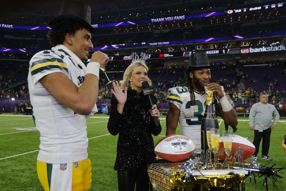 Green Bay Packers' Jordan Love and Aaron Jones celebrate after an NFL football game against the Minnesota Vikings Sunday, Dec. 31, 2023, in Minneapolis. The Packers won 33-10. (AP Photo/Bruce Kluckhohn)