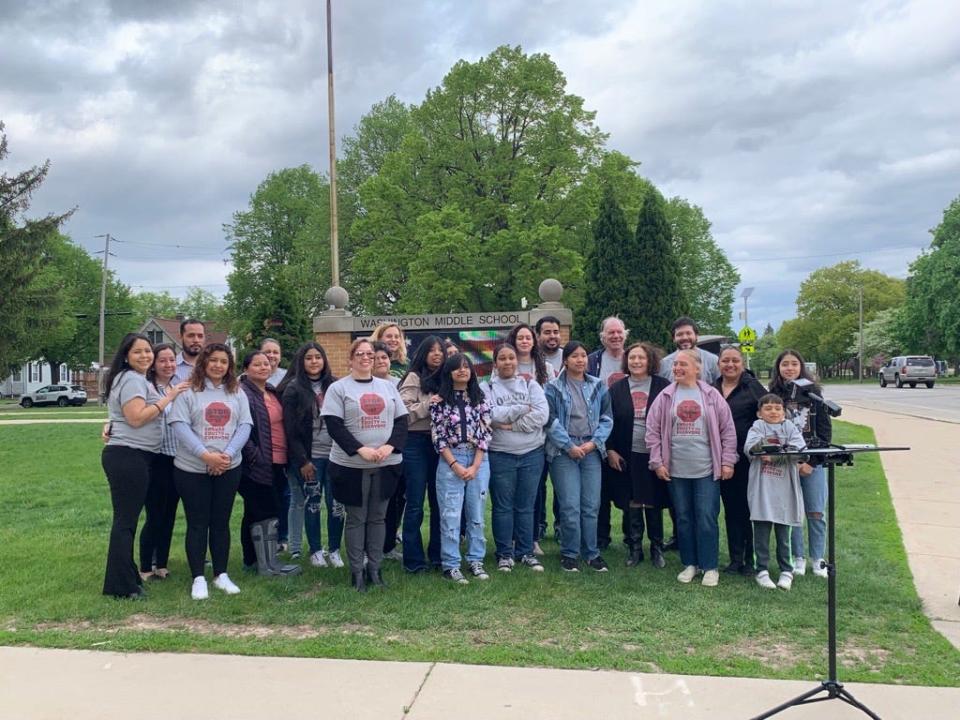Members of the Northeast Wisconsin Latino Education Task Force gather outside Washington Middle School on May 19 in Green Bay. The group is calling for the Green Bay School Board to stop a plan to close 11 schools.