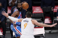 Orlando Magic center Nikola Vucevic, right, guards Brooklyn Nets guard James Harden, left, during the first half of an NBA basketball game, Saturday, Jan. 16, 2021, in New York. (AP Photo/Mary Altaffer)