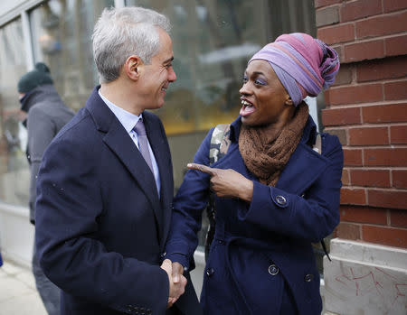 Chicago Mayor Rahm Emanuel shares a laugh with a potential voter while campaigning on election day in Chicago, Illinois, February 24, 2015. REUTERS/Jim Young