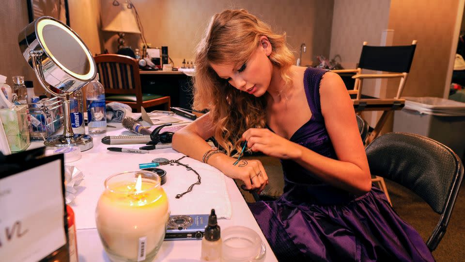 Early in her career, Taylor Swift would often perform with the number 13 — which the singer considers lucky — written on her hand.  - Larry Busacca/Getty Images