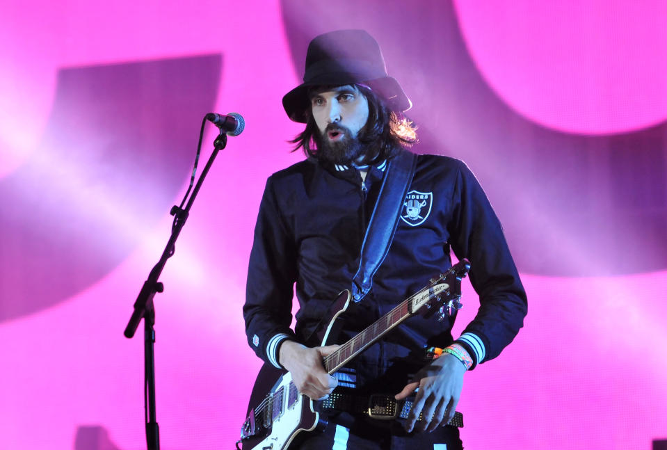 GLASTONBURY, ENGLAND - JUNE 29:  Serge Pizzorno of Kasabian performs on the Pyramid stage during day three of the Glastonbury Festival at Worthy Farm in Pilton on June 29, 2014 in Glastonbury, England. Tickets to the event, which is now in its 44th year, sold out in minutes even before any of the headline acts had been confirmed. The festival, which started in 1970 when several hundred hippies paid £1, now attracts more than 175,000 people.  (Photo by Jim Dyson/Getty Images)