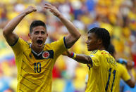 Colombia's James Rodriguez (L) celebrates next to teammate Juan Cuadrado scoring against Ivory Coast during their 2014 World Cup, June 19, 2014. (REUTERS/Paul Hanna)