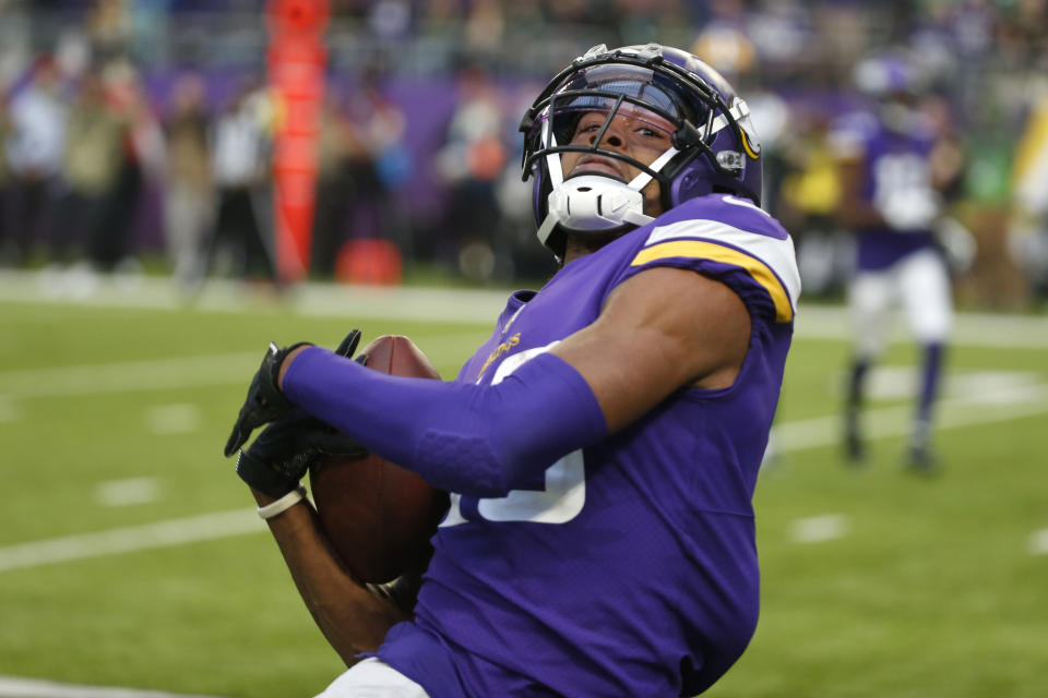 Minnesota Vikings wide receiver Justin Jefferson (18) catches a 23-yard touchdown pass during the second half of an NFL football game against the Green Bay Packers, Sunday, Nov. 21, 2021, in Minneapolis. (AP Photo/Bruce Kluckhohn)