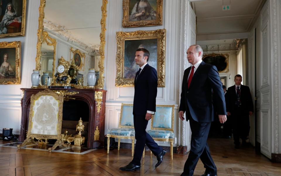 President Emmanuel Macron walks with his Russian counterpart Vladimir Putin - Credit: Philippe Wojazer/Pool Photo via AP