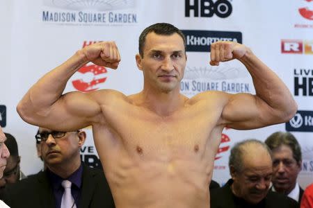Reigning heavyweight champion Wladimir Klitschko of Ukraine clenches his fists during an official weigh-in ahead of his fight in New York April 24, 2015. REUTERS/Eduardo Munoz