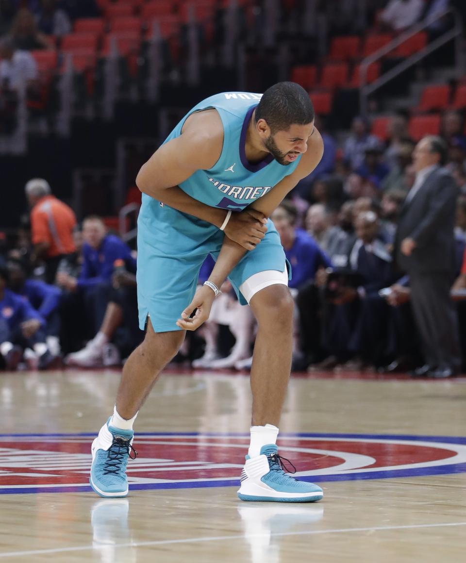 The Hornets’ Nicolas Batum holds his arm during the first half of Wednesday’s preseason game against Detroit. (AP Photo/Carlos Osorio)