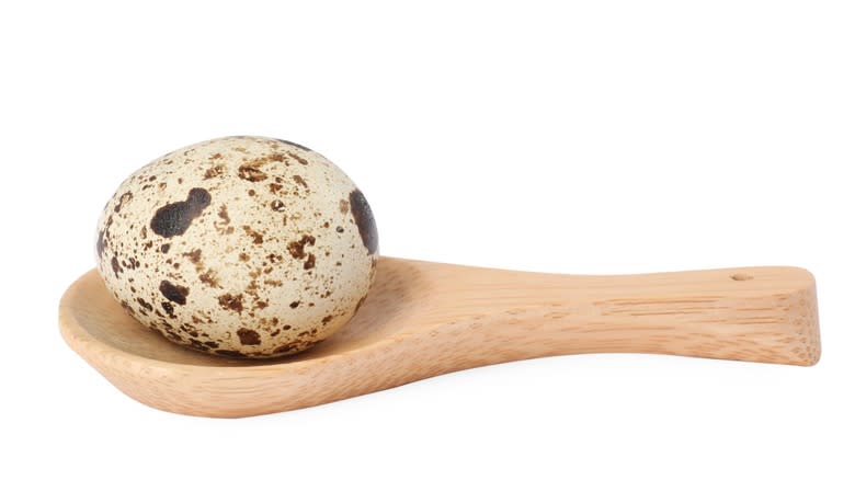 quail egg on spoon