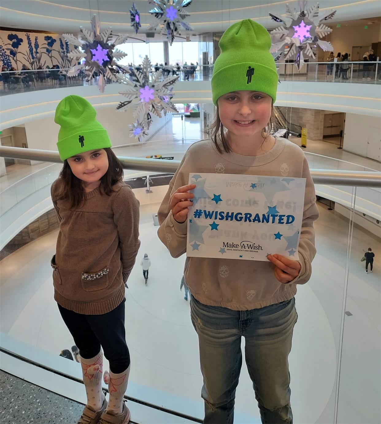 Nora Meek, right, and her sister Lila take a picture at the Mall of America during a Make-A-Wish trip. Nora was diagnosed with a brain tumor in September.
