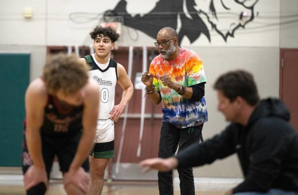 Pitman coach Harvey Marable, middle, talks with Kaulin Davoud during the Central California Athletic League game with Modesto in Turlock, Calif., Friday, Jan. 26, 2024.
