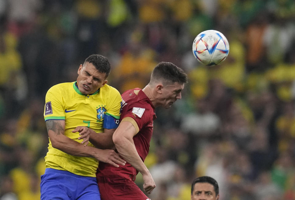 Serbia's Dusan Vlahovic, right, and Brazil's Thiago Silva, go for a header during the World Cup group G soccer match at the Lusail Stadium in Lusail, Qatar, Thursday, Nov. 24, 2022. (AP Photo/Themba Hadebe)