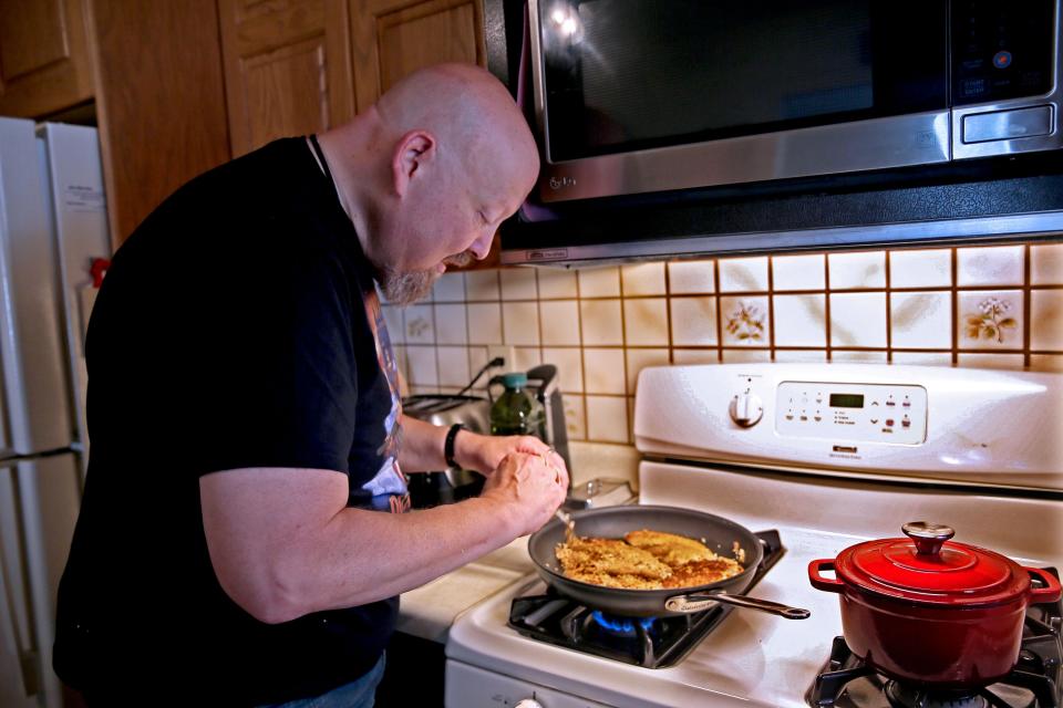 Jim Garvey cooks panko covered tilapia while preparing dinner for his family on  in Kewaskum.