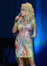 <p>Here, Parton's dress pays homage to one of her most beloved songs, "Coat of Many Colors," inspired by her own childhood experience. This beaded rainbow overlay with rhinestones is Dolly at her finest. </p>