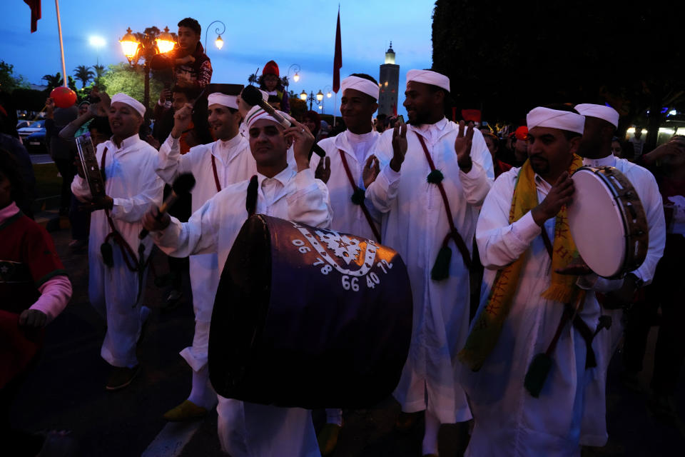 Moroccans celebrate in Rabat, Morocco, Saturday Dec. 10, 2022 their team's victory over Portugal in the World Cup quarter final soccer match played in Qatar. (AP Photo/Mosa'ab Elshamy)