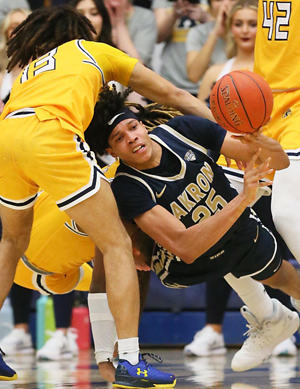 Kent State's Jalen Sullinger defends as Akron's Enrique Freeman tries to pass Friday night the M.A.C. Center in Kent.