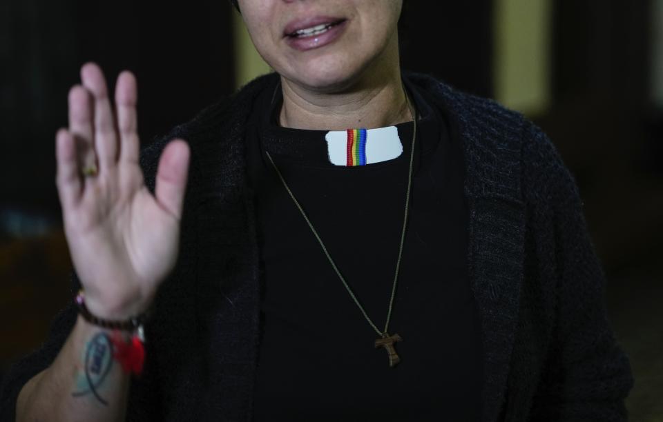 Rev. Elaine Saralegui, wearing a rainbow flag on her clerical collar, talks at the end of a service at the Metropolitan Community Church, an LGBTQ+ inclusive house of worship, in Matanzas, Cuba, Friday, Feb. 2, 2024. “This church is a family,” said Saralegui, who has a tattoo of the Jesus fish on one of her forearms and wears a Buddhist bracelet. (AP Photo/Ramon Espinosa)