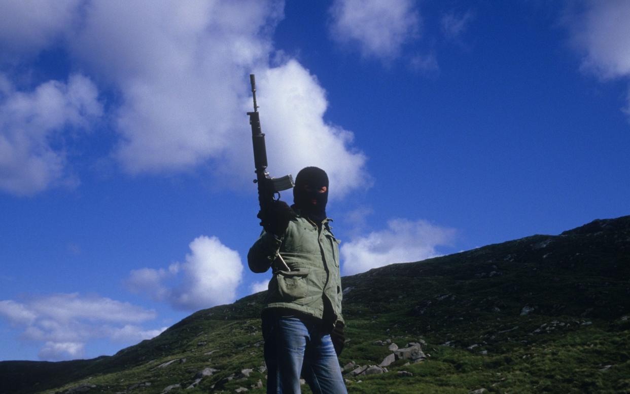 An IRA gunman in Co Tyrone in 1986; the group features throughout Cross