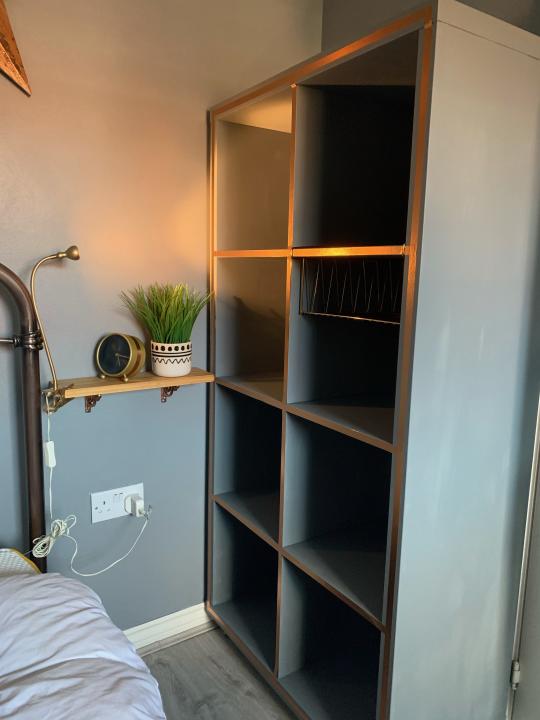 black shelving in a grey bedroom