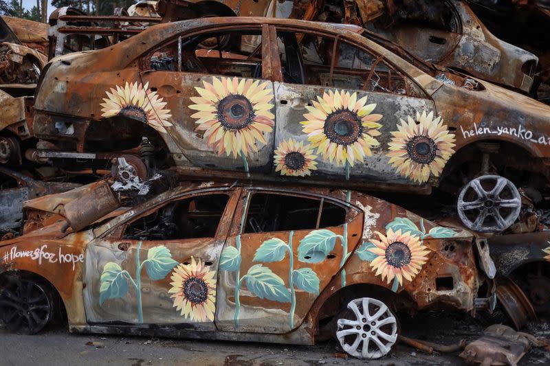 Artists painte cars destroyed during Russia's attack on Ukraine in Irpin