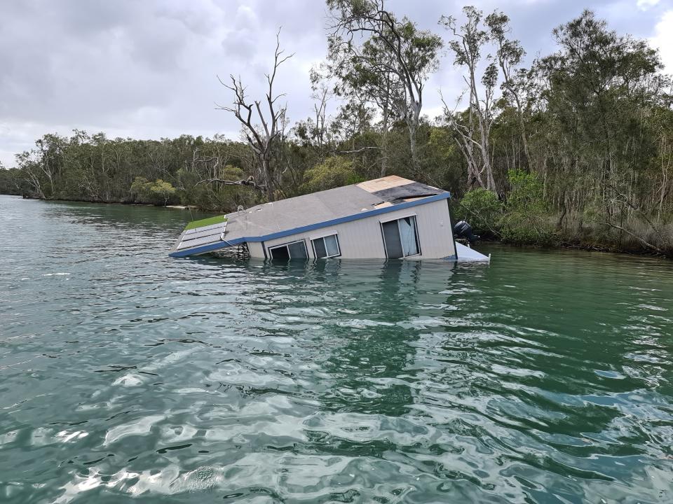 A houseboat pictured sinking in Noosa River.