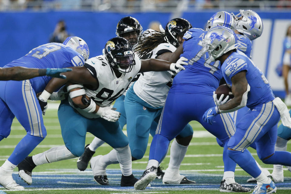 Jacksonville Jaguars defensive tackle Folorunso Fatukasi (94) looks to Detroit Lions running back Jamaal Williams (30) during the second half of an NFL football game, Sunday, Dec. 4, 2022, in Detroit. (AP Photo/Duane Burleson)