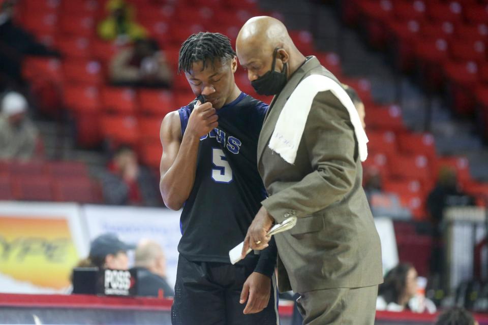 Southeast head coach Sean McDaniel talks to Michael Graham during a 5A semifinal game between Memorial and Southeast at Lloyd Noble Center in Norman, Okla. on Friday, March 11, 2022. 