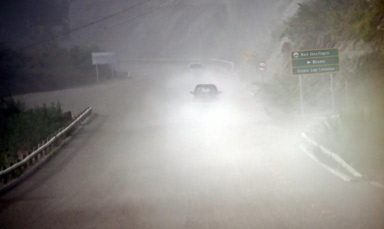 Cars are seen amid volcanic ashes from the Calbuco volcano in La Ensenada, on April 23, 2015