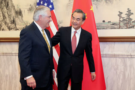 Chinese Foreign Minister Wang Yi (R) talks with U.S. Secretary of State Rex Tillerson at Diaoyutai State Guesthouse on March 18, 2017 in Beijing, China. REUTERS/ Lintao Zhang/POOL