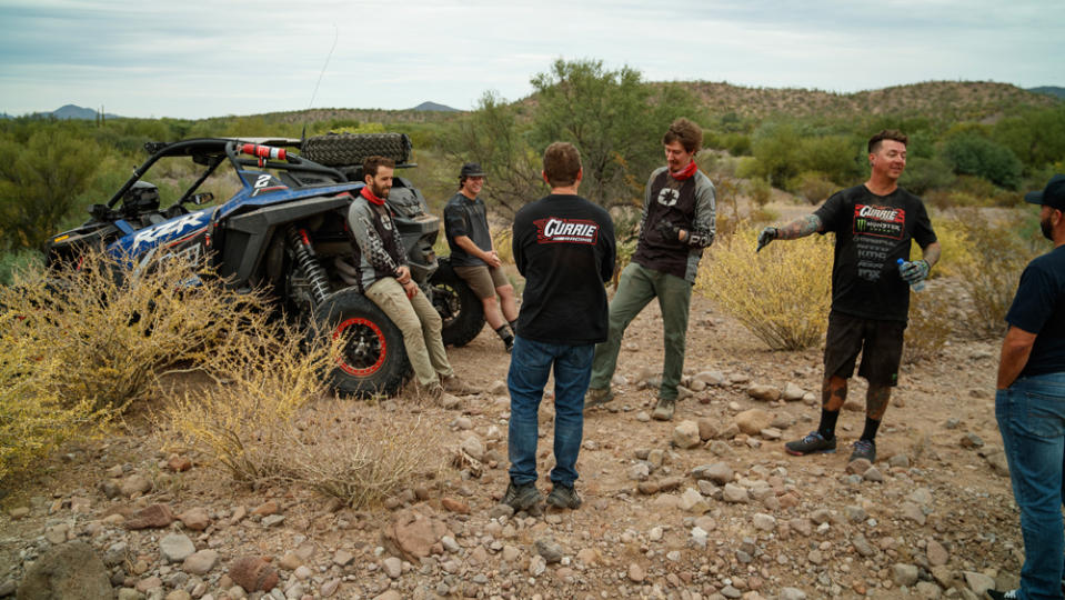 Off-road drivers and passengers take a break from pre-running the Baja 1000.