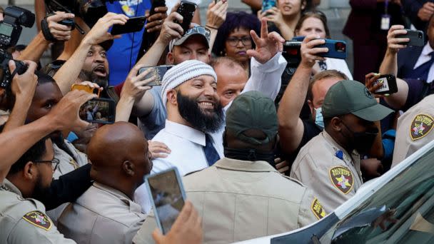 PHOTO: Adnan Syed, whose case was chronicled in the hit podcast 'Serial' smiles and waves as he heads to a vehicle after exiting the courthouse after a judge overturned Syed's 2000 murder conviction during a hearing in Baltimore, Sept. 19, 2022. (Evelyn Hockstein/Reuters)
