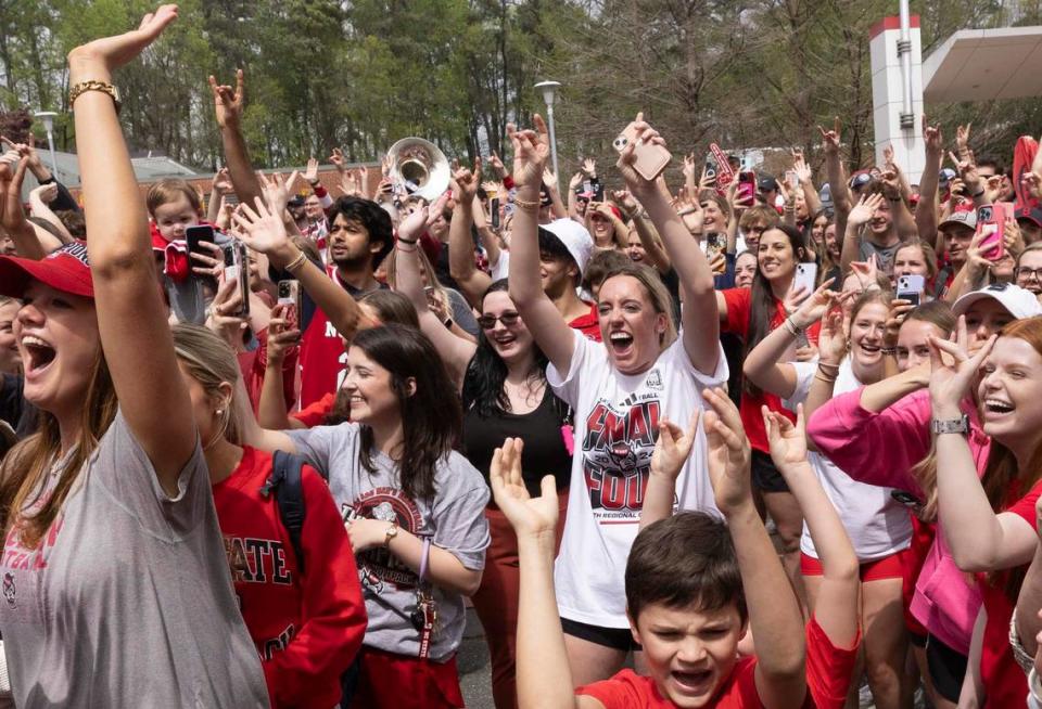 NC.State fans cheer as a bus carrying the men’s basketball team departs campus Wednesday, April 3, 2024. The team is headed to the Final Four for the first time since 1983.