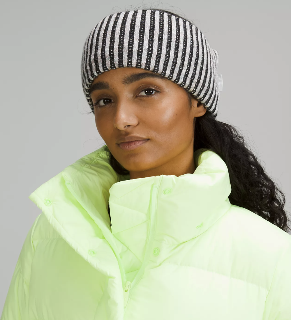 A woman wearing a Textured Fleece-Lined Knit Ear Warmer. (Photo via Lululemon)