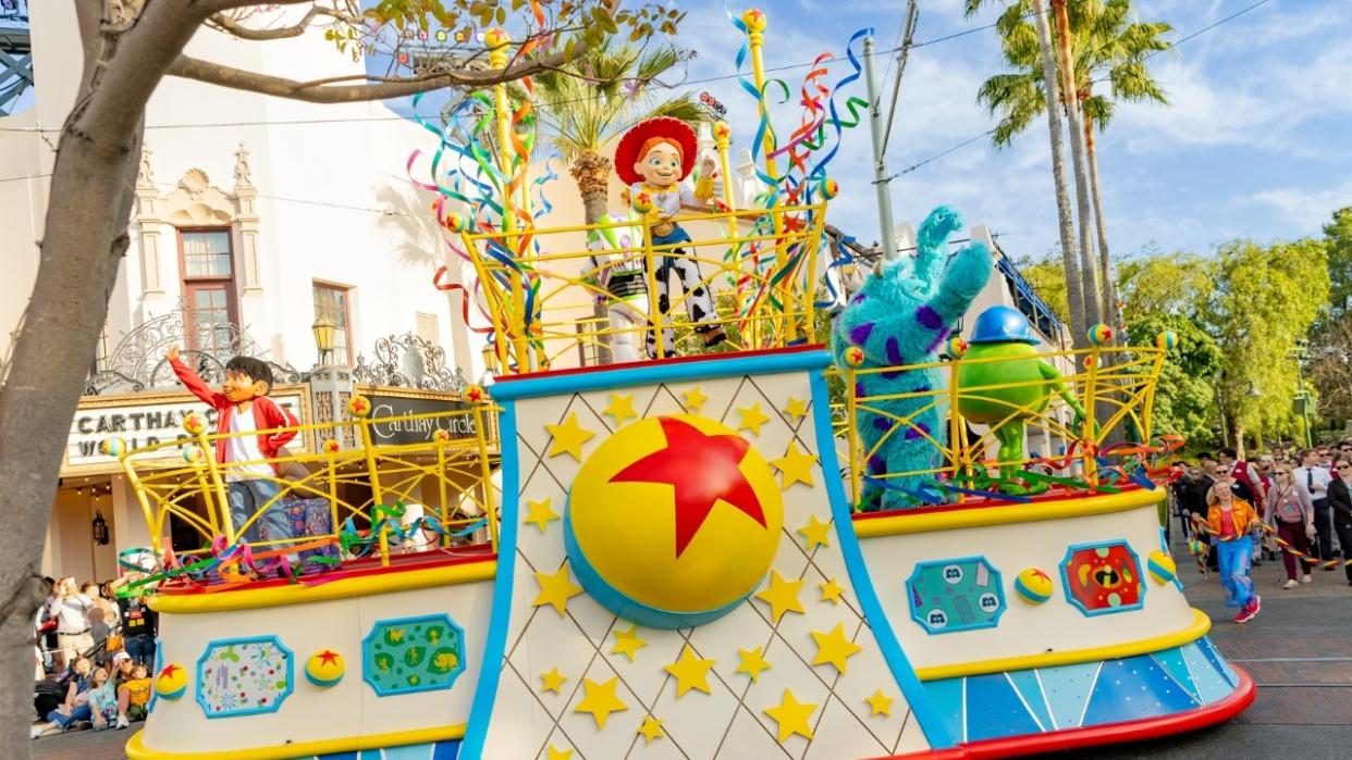  Miguel from Coco, Jessie from Toy Story, and Mike and Sully from Monsters Inc on a parade float at Disney California Adventure. 